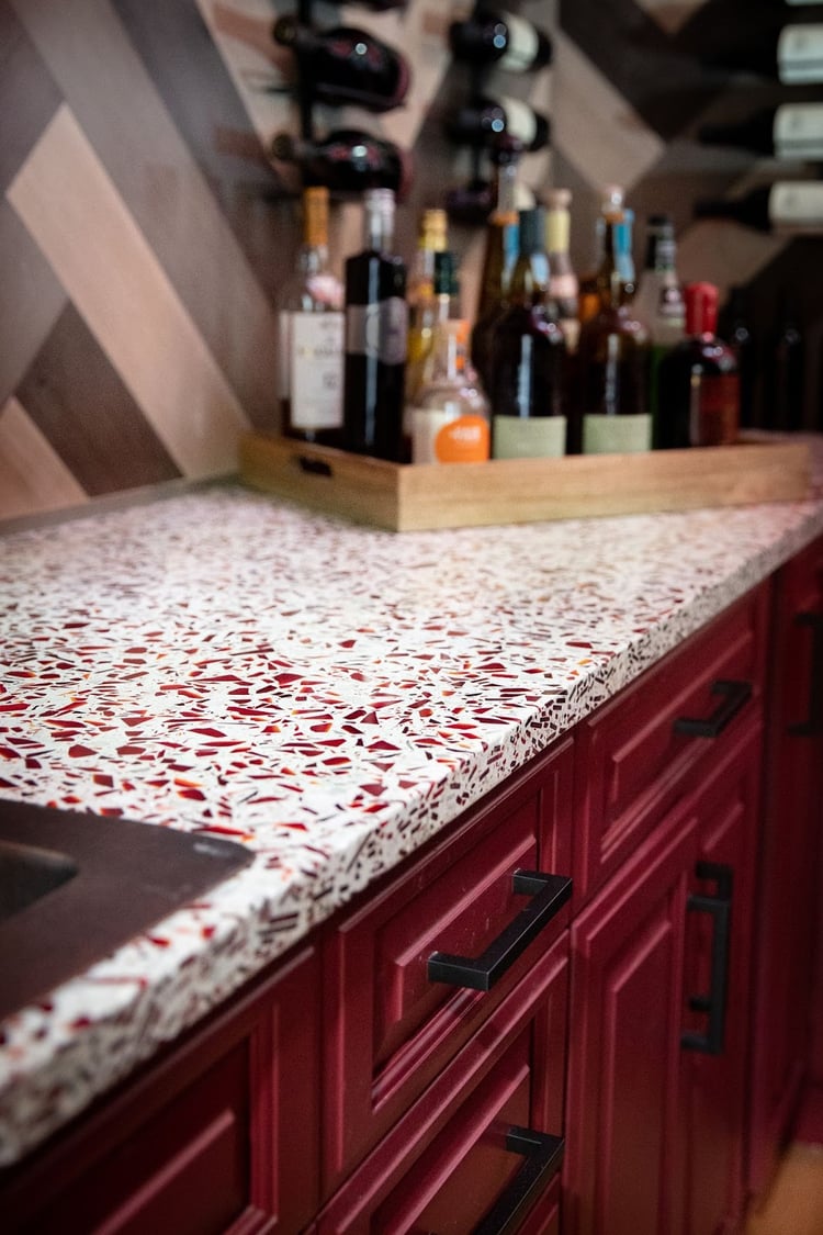 Cabinets were up cycled from a home demo and painted a deep burgundy to match the design and Ruby Red countertops 
