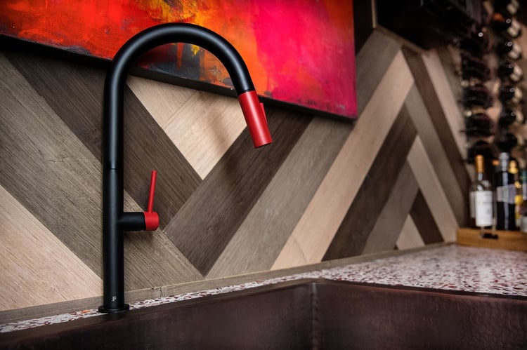 Rachel worked with San Diego artist Pnina Gold to get the artwork that ties the room together, hung over the wood plank panel walls and copper sink
